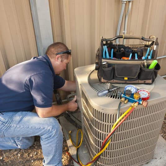 A/C technician working on an air conditioner that keeps cycling at a home in Rockwall.