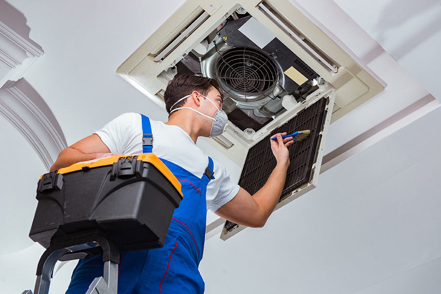 technician working on an air conditioning system