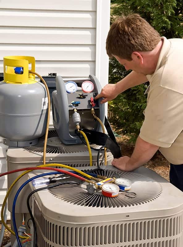 HVAC technician doing maintenance on an ac unit at a home in Sachse, TX